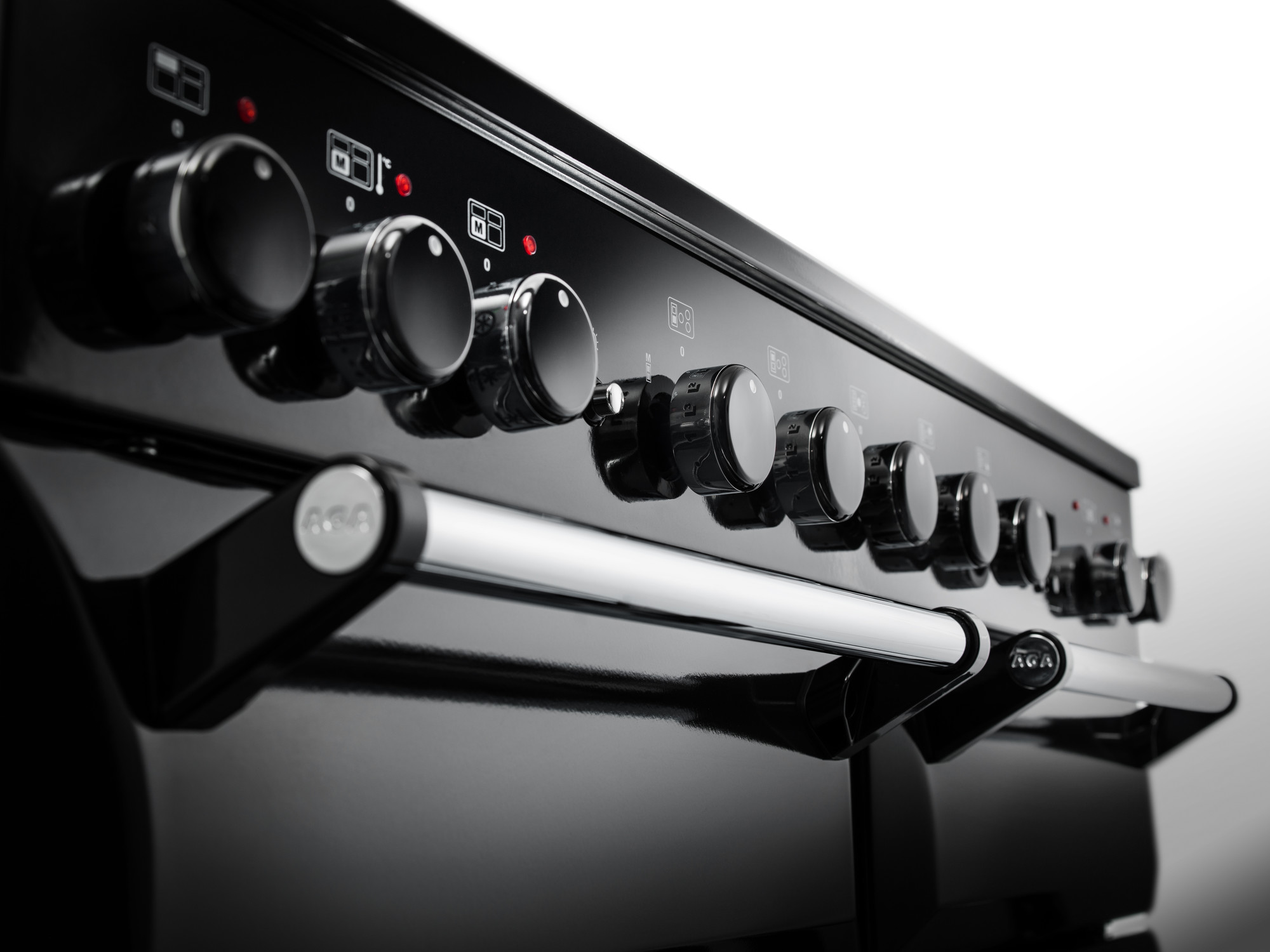 Nahaufnahme eines eleganten schwarzen Herdes mit mehreren Bedienelementen und silbernen Griffen