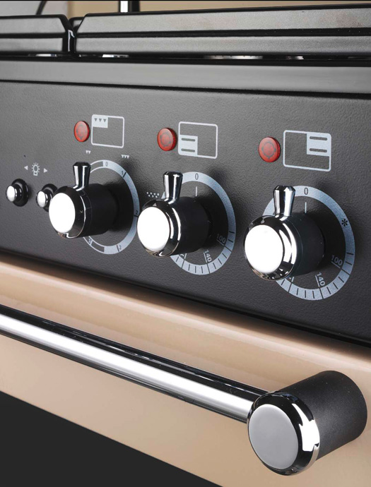 Nahaufnahme eines Bedienfelds mit drei Drehknöpfen und Kontrollleuchten an einem Herdbedienfeld in einer modernen Küche.